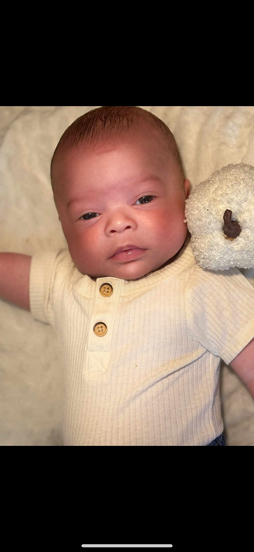 Azarin is registered to the contest to win money with this photo: baby, infant, face, child, cute, teddy_bear, plush_toy, blanket, clothing, ribbed_shirt, wooden_buttons, portrait, soft_light, lying_down, comfort, innocence, skin, expression, warm_colors, closeup