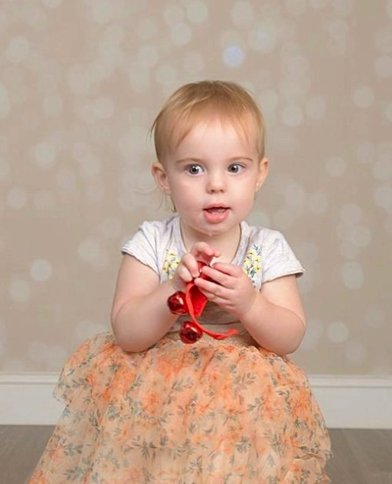 Evalyn is registered to the contest to win money with this photo: baby_toddler_clothing, cheek, child, cocktail_dress, day_dress, dress, embellishment, fashion_design, formal_wear, happy, one_piece_garment, pattern, peach, person, pink, portrait_photography, ruffle, sitting, skin, sleeve