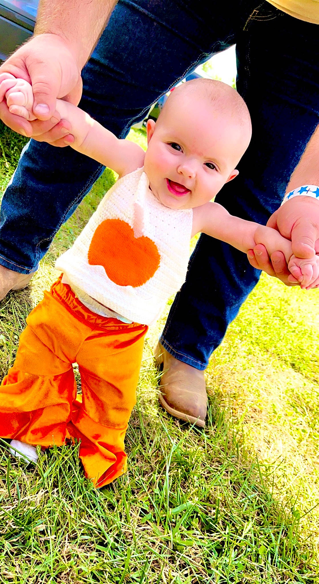 Ryleigh is registered to the contest to win money with this photo: baby, baby_toddler_clothing, ball, child, clothing, finger, fun, gesture, grass, hand, happy, leisure, people_in_nature, person, plant, playing_with_kids, recreation, smile, t_shirt, thumb