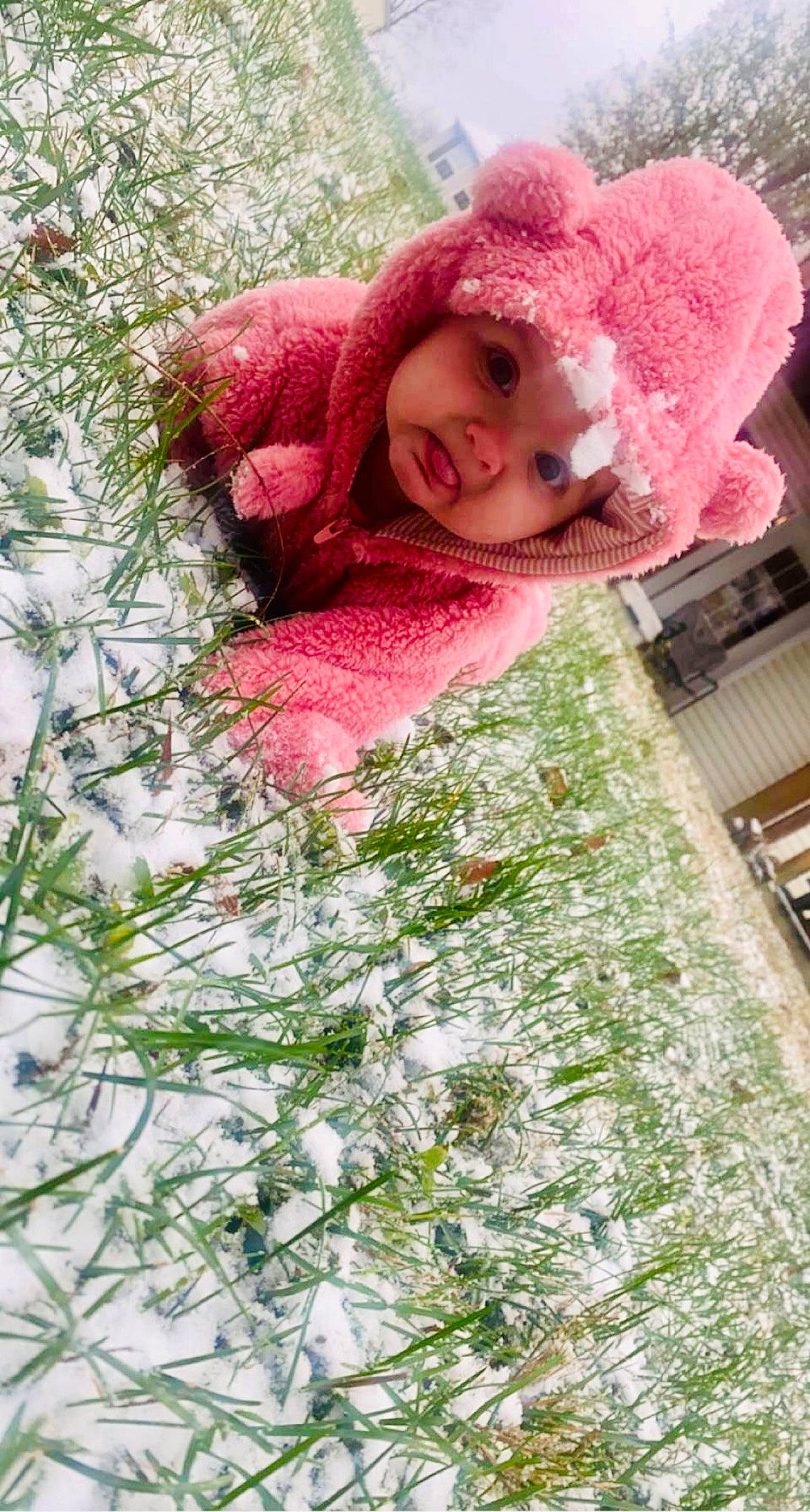 Ryleigh is registered to the contest to win money with this photo: baby, beanie, cap, child, fashion_accessory, fur, grass, happy, headwear, knit_cap, linens, magenta, pattern, people_in_nature, person, petal, pink, plant, smile, textile