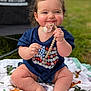 Amelia is registered to the contest to win money with this photo: baby, blanket, blue_shirt, chair, child, cute, dinosaur_print, foot, grass, hair_bows, hand, happy, infant, outdoor, pacifier, playful, sitting, skin, smile, toy
