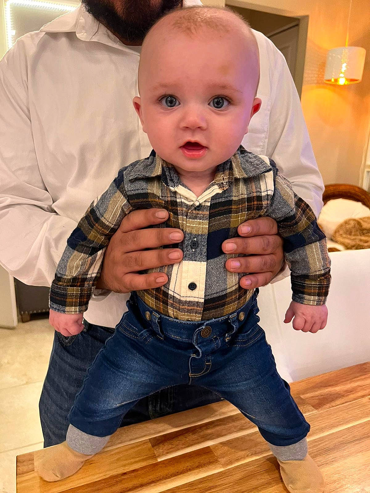 River joined the competition — help win amazing prizes! baby, baby_toddler_clothing, cheek, child, collar, comfort, denim, dress_shirt, fashion_design, flooring, hardwood, jeans, lamp, pattern, person, sitting, sleeve, toddler, varnish, wood