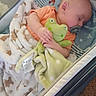 Noah is registered to the contest to win money with this photo: baby, sleeping, crib, blanket, plush_toy, frog, pacifier, infant, cozy, child, resting, soft_toy, bedtime, comfort, cute, indoors, peaceful, person, toddler, sleep
