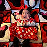 baby, infant, child, minnie_mouse, costume, red_dress, polka_dots, bow, headband, smiling, happy, sitting, portrait, crocheted_blanket, colorful, red, black, white, indoor, close_up