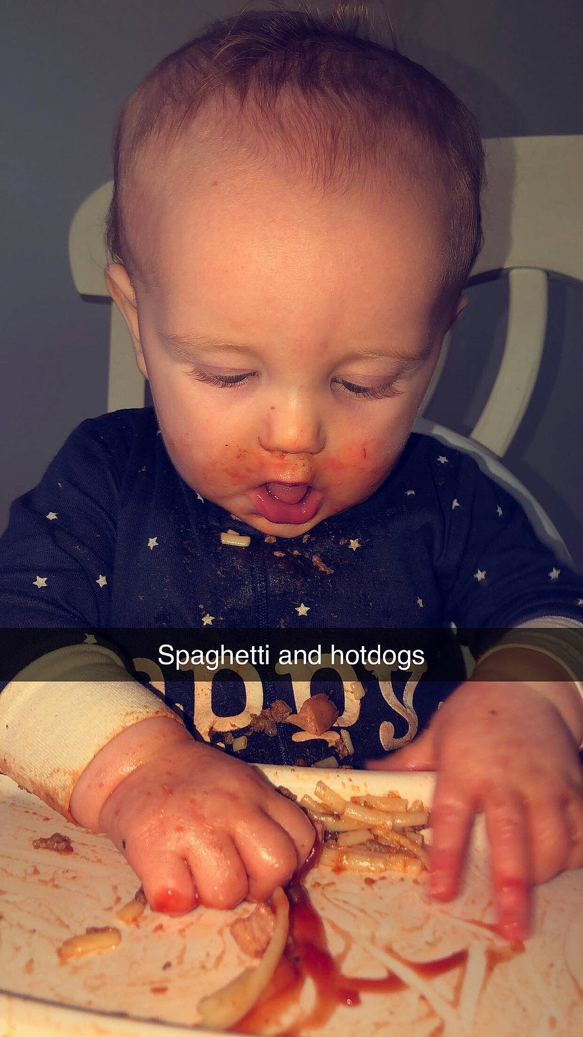 Travis is registered to the contest to win money with this photo: baby, cheek, child, chin, comfort_food, eating, face, finger, food, forehead, hand, head, lip, mouth, nose, person, play, skin, toddler, tummy_time