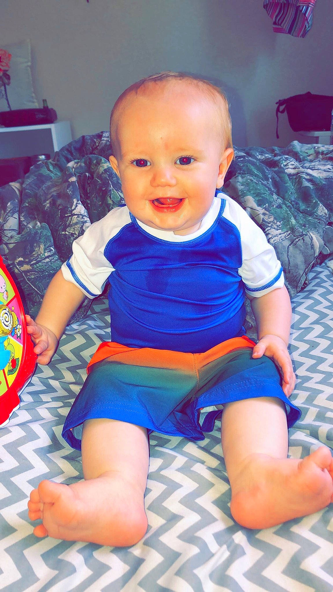 Travis is registered to the contest to win money with this photo: baby, baby_products, baby_toddler_clothing, blue, cheek, child, diaper, joy, person, play, sitting, toddler