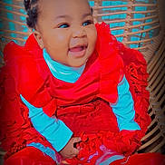 Flourish joined the competition — help win amazing prizes! baby, child, smiling, red_dress, wicker_chair, happy, portrait, indoor, person, infant, cute, frilly_clothing, hand, seat, fashion, bright_colors, childrens_fashion, face, sitting, expression