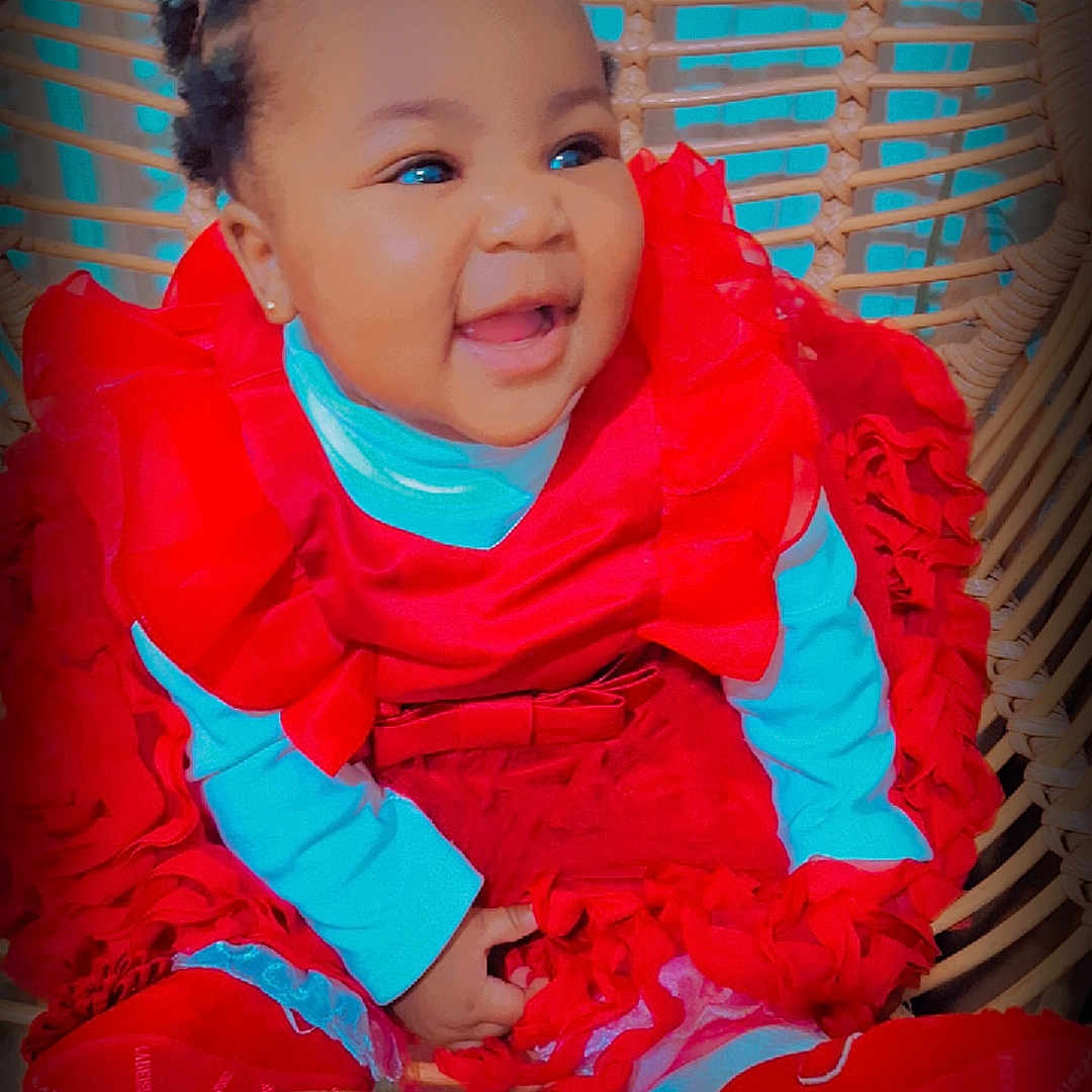 Flourish joined the competition — help win amazing prizes! baby, bright_colors, child, childrens_fashion, cute, expression, face, fashion, frilly_clothing, hand, happy, indoor, infant, person, portrait, red_dress, seat, sitting, smiling, wicker_chair