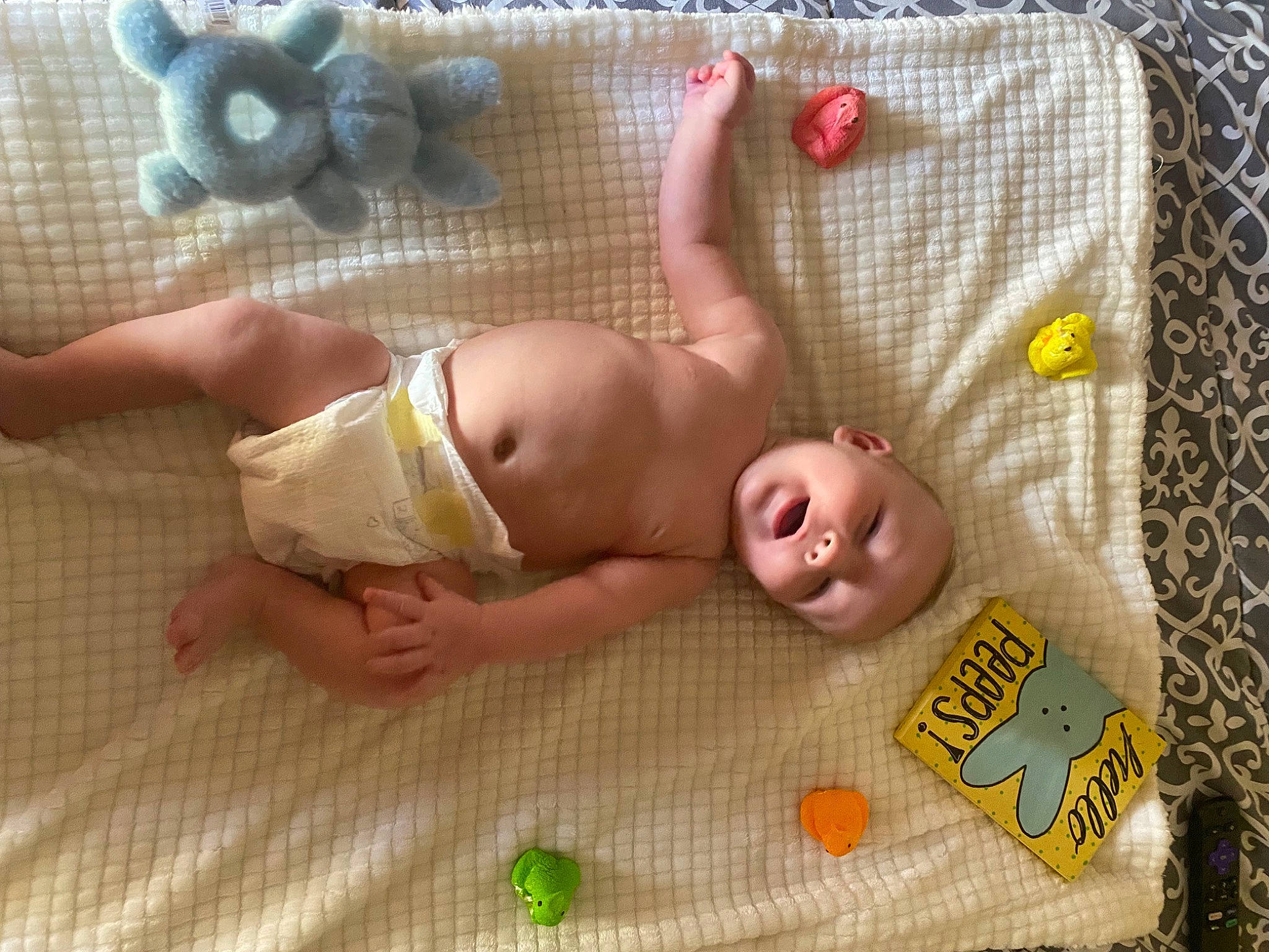Blake is registered to the contest to win money with this photo: baby, baby_products, baby_toddler_clothing, baby_toys, child, comfort, diaper, finger, flooring, foot, fun, human_leg, leg, linens, mammal, person, product, textile, thigh, toddler