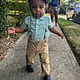 Daxon Dodds joined the competition — help win amazing prizes! toddler, child, sidewalk, green_checkered_cap, suspenders, khaki_pants, black_shoes, young_woman, barefoot, casual_clothing, suburban, grass, bushes, car, residential_area, summer, daylight, walking, outdoor, person