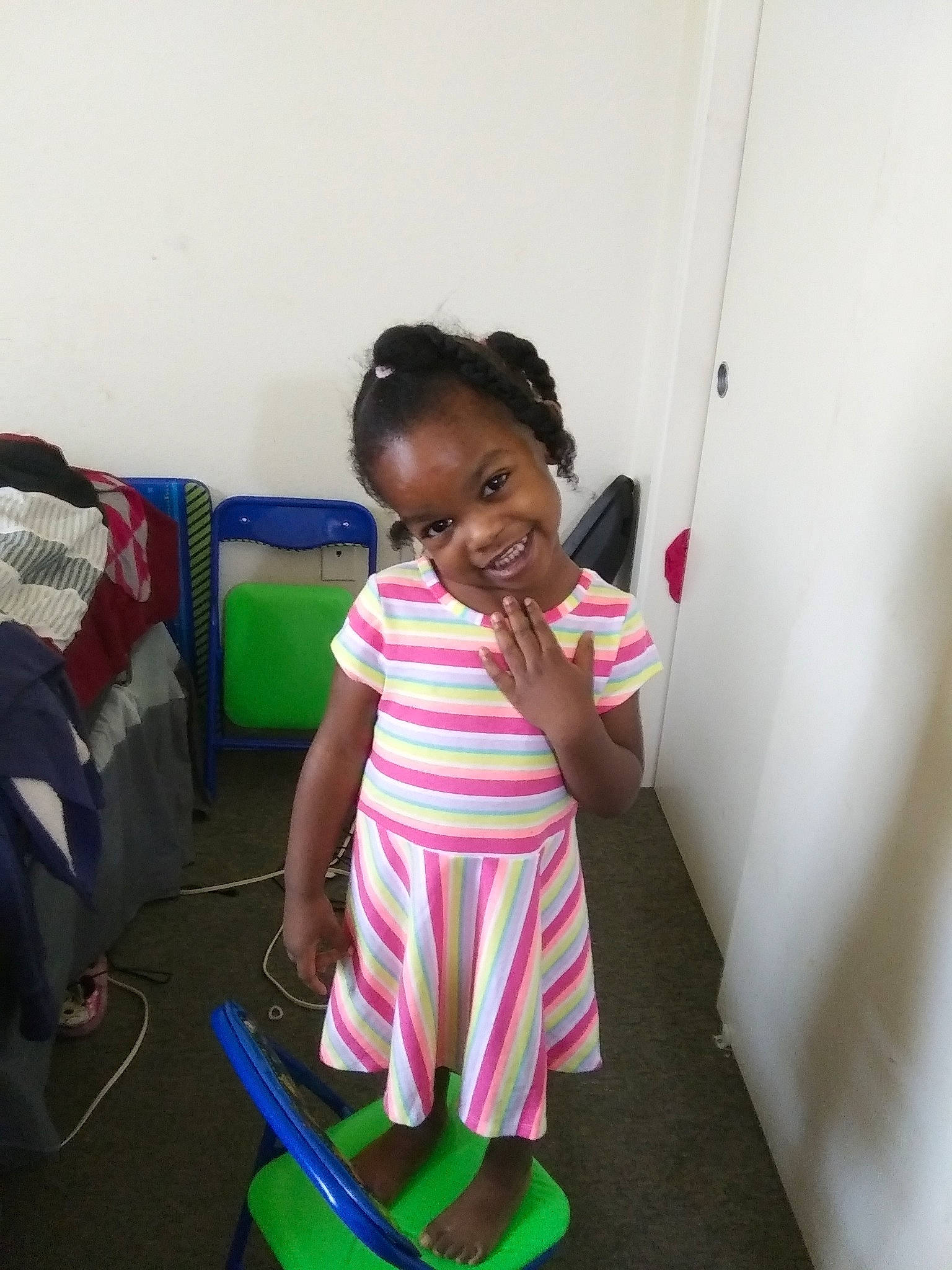 Yalanda is registered to the contest to win money with this photo: child, electronic_device, fun, joy, person, play, smile, standing, technology, toddler