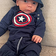 Lyo a rejoint le concours — aidez-le/la à gagner de superbes lots ! baby, infant, child, person, hat, bucket_hat, clothing, navy_blue, shirt, pants, socks, sofa, couch, fabric, face, eyes, hands, cute, indoor, portrait