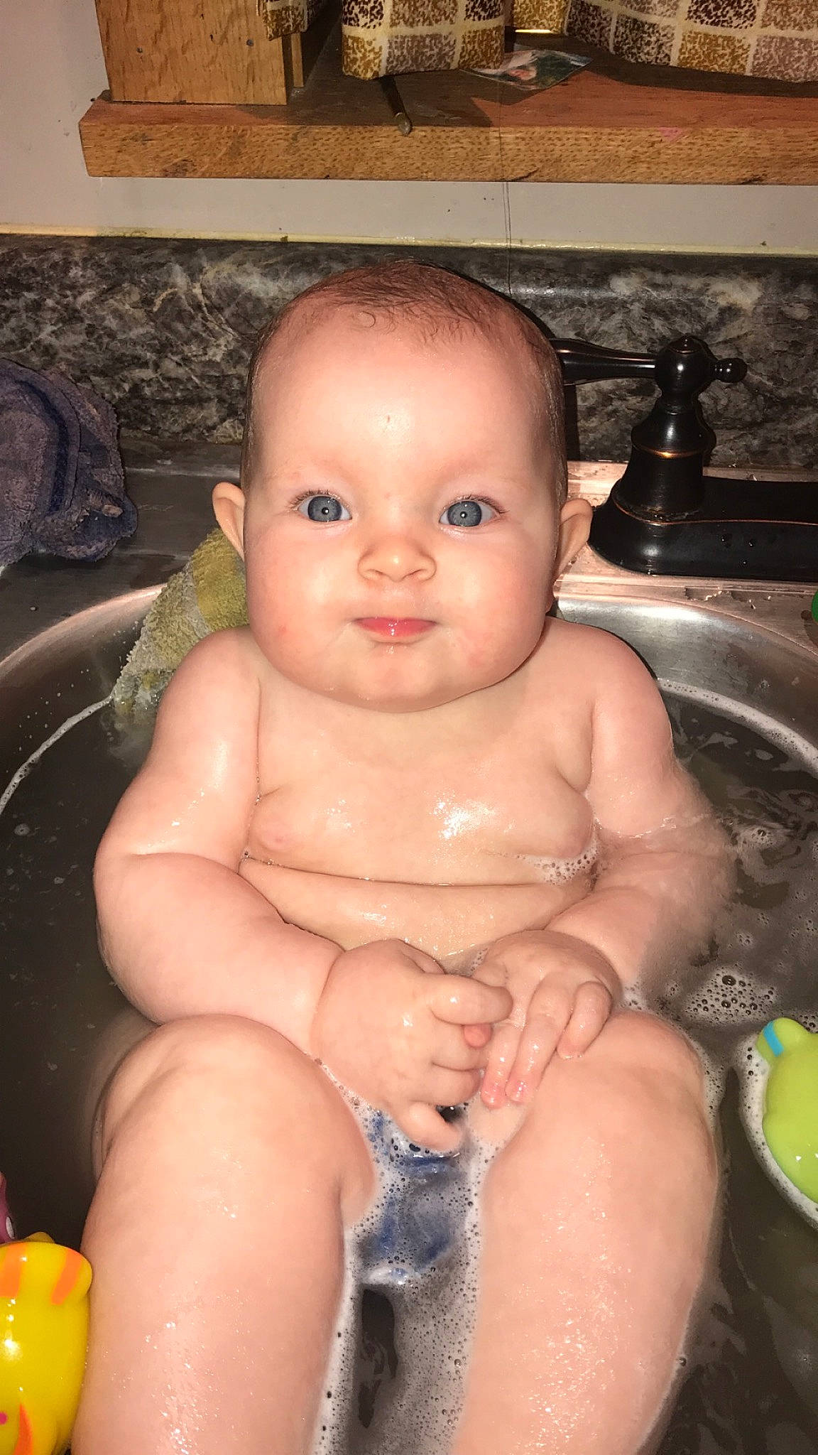 Gwendolyn is registered to the contest to win money with this photo: baby, baby_bathing, cheek, chest, eye, eyelash, finger, fluid, hand, head, human_body, iris, lip, mouth, neck, nose, person, plumbing_fixture, sink, skin