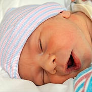 Samuel is registered to the contest to win money with this photo: newborn, baby, sleeping, hat, striped_hat, infant, closeup, face, soft, blanket, cozy, peaceful, cute, resting, skin, mouth, nose, headwear, portrait, child