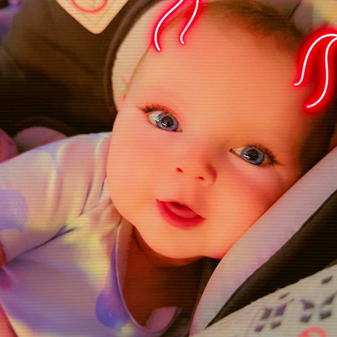 Novaann is registered to the contest to win money with this photo: baby, bodypart, bonnet, car, car_interior, carseat, clothing, cushion, face, finger, hand, hat, head, homedecor, light, person, photography, portrait, transportation, vehicle