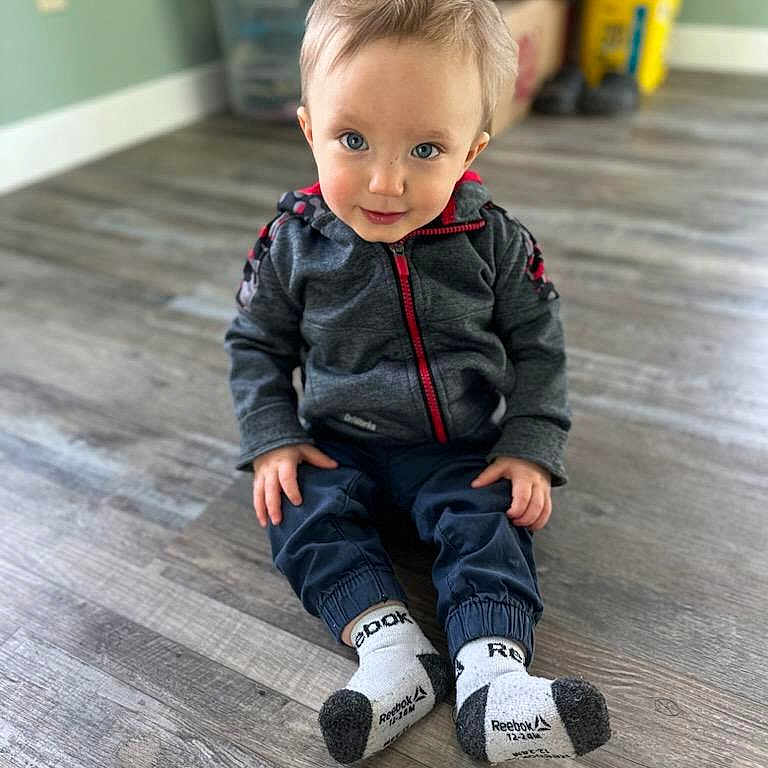 Greyson is registered to the contest to win money with this photo: boy, child, clothing, coat, crawling, face, footwear, hair, head, hosiery, jacket, jeans, male, pants, person, photography, portrait, shoe, sitting, sock