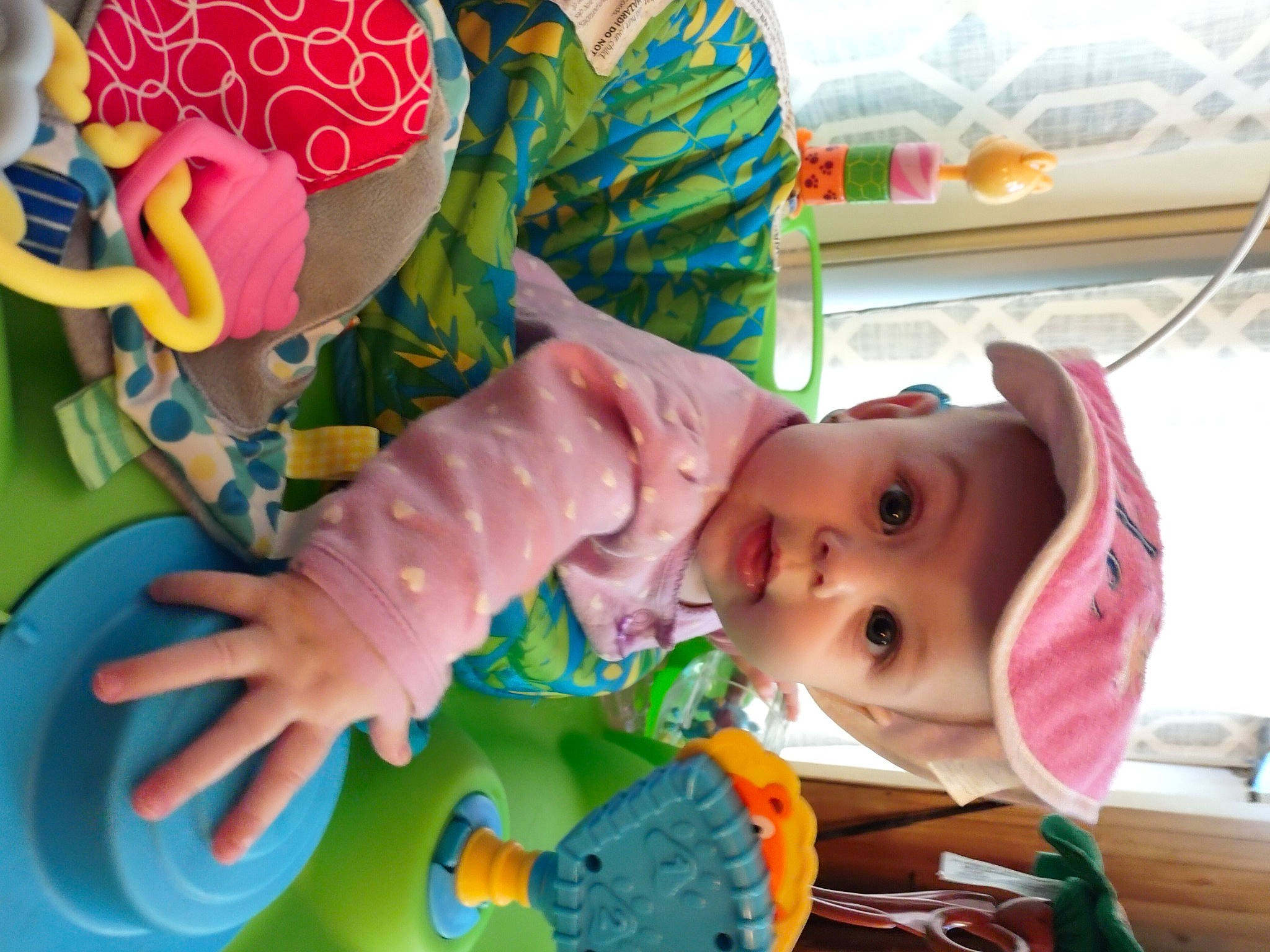 Kingsley is registered to the contest to win money with this photo: baby, baby_playing_with_toys, baby_products, baby_safety, baby_toddler_clothing, baby_toys, cheek, child, fun, green, happy, headwear, linens, person, pink, play, product, room, skin, textile