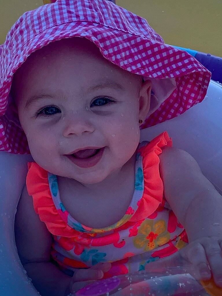 Kingsley is registered to the contest to win money with this photo: azure, baby, baby_toddler_clothing, cap, cool, eye, face, happy, hat, head, headgear, headwear, joy, lip, person, pink, purple, red, skin, smile