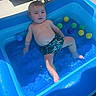 Nino participe au concours pour gagner de l'argent avec cette photo : baby, child, pool, water, inflatable_pool, swimwear, shorts, balls, sunlight, outdoor, summer, play, fun, relaxation, cute, happy, splash, skin, toddlers, blue