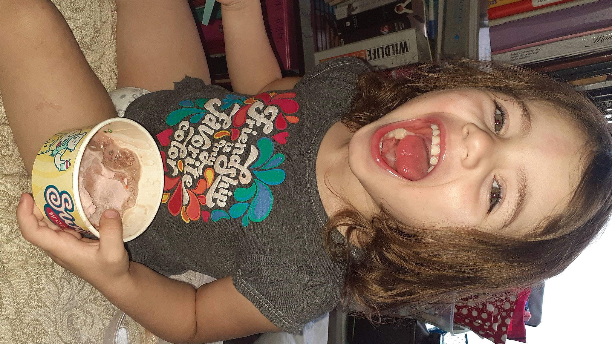 Briella is registered to the contest to win money with this photo: arm, ear, eye, eyelash, face, finger, food, fun, hand, happy, head, human_body, iris, mouth, nail, neck, nose, organ, person, skin