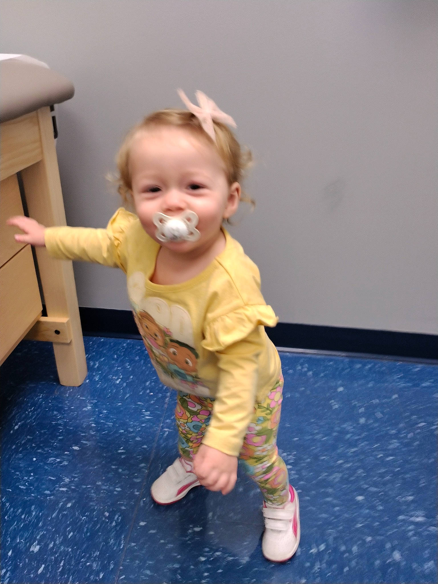 Olivia is registered to the contest to win money with this photo: baby, baby_toddler_clothing, cheek, child, chin, drawer, floor, flooring, foot, fun, happy, hardwood, head, human_leg, person, shoe, skin, sleeve, smile, toddler