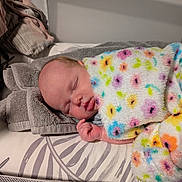 Lilith joined the competition — help win amazing prizes! baby, sleeping, blanket, colorful, floral, towel, bed, resting, infant, peaceful, soft, cozy, child, portrait, indoors, cute, newborn, comfort, relaxation, face