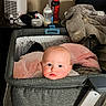 Lilith is registered to the contest to win money with this photo: baby, bassinet, blanket, bottle, child, cozy, cute, face, furniture, gray, home, humidifier, indoor, infant, person, pink, portrait, resting, soft