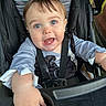 Xavier joined the competition — help win amazing prizes! baby, child, stroller, blue_eyes, drool, curious, clothing, seatbelt, hand, portrait, infant, outdoor, expression, person, cute, face, toddler, sitting, playful, young