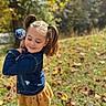 child, girl, pigtails, denim_jacket, yellow_skirt, outdoor, grass, leaves, fall, sunlight, smile, happy, cute, nature, portrait, playful, seasonal, young, person, fashion