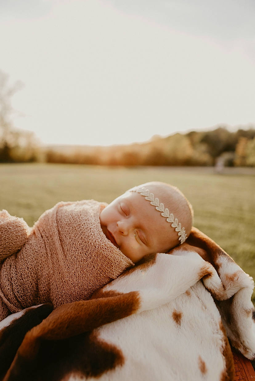 Harleigh is registered to the contest to win money with this photo: baby, baby_toddler_clothing, beanie, cheek, child, comfort, facial_expression, flash_photography, fun, grass, happy, headgear, horizon, people_in_nature, person, portrait_photography, sitting, skin, sky, toddler