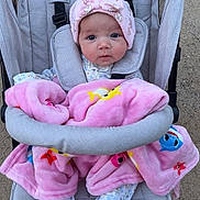 Gracelynn joined the competition — help win amazing prizes! baby, blanket, child, colorful, cozy, cute, expression, face, footwear, hat, infant, outdoor, pajamas, person, pink, safety_strap, seated, stroller, wheels, young