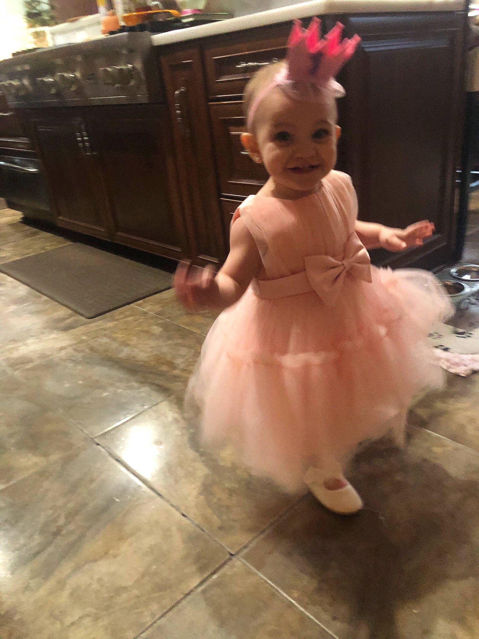Avyanna is registered to the contest to win money with this photo: baby, baby_toddler_clothing, cabinetry, chest_of_drawers, child, day_dress, drawer, dress, event, floor, flooring, fun, hand, hardwood, human_body, human_leg, joy, person, photograph, smile