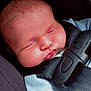 Sebastian is registered to the contest to win money with this photo: baby, sleeping, car_seat, harness, face, child, infant, cheeks, closed_eyes, clothing, blue_sweater, safety, seatbelt, cute, peaceful, resting, newborn, head, skin, strap