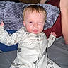Oakley joined the competition — help win amazing prizes! baby, onesie, pillow, indoor, person, hand, controller, furniture, wood, sleepy, child, soft_texture, blanket, casual, relaxing, home, gaming, pajamas, infant, couch