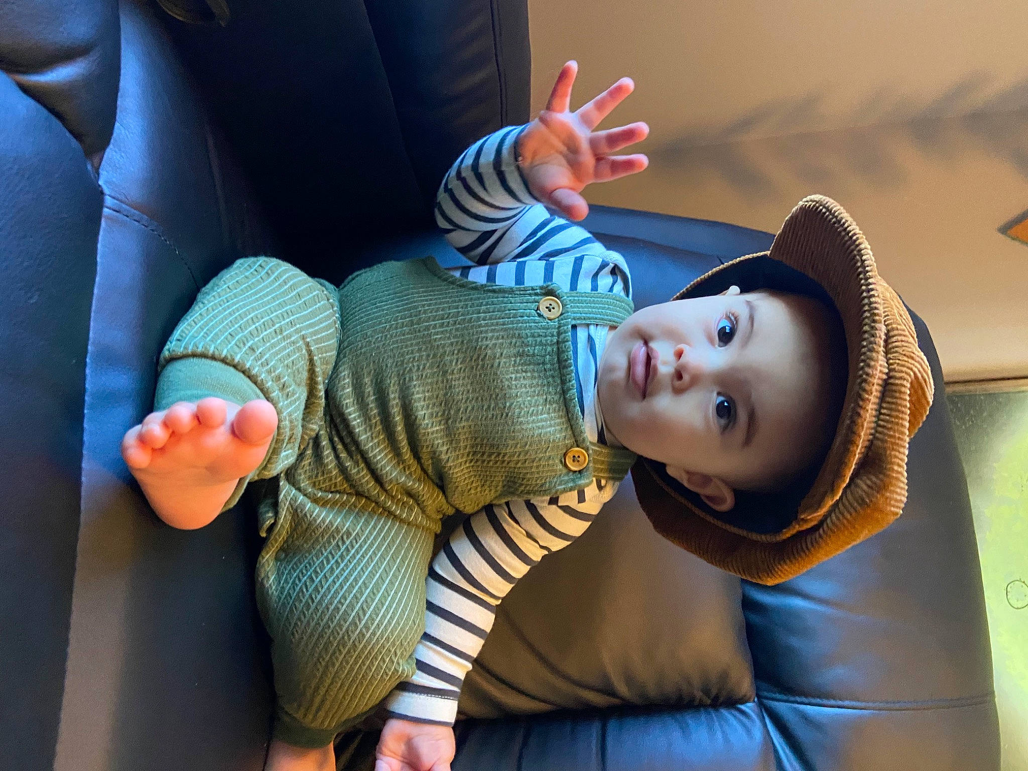 Indie is registered to the contest to win money with this photo: azure, comfort, cool, elbow, finger, gesture, hand, hat, headgear, human_body, knee, leg, mammal, mouth, person, sleeve, sun_hat, thigh, thumb, vertebrate