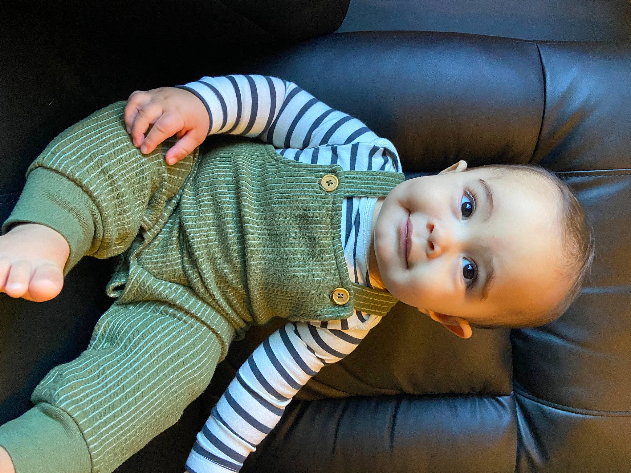 Indie is registered to the contest to win money with this photo: baby, baby_toddler_clothing, child, comfort, finger, flash_photography, foot, gesture, human_body, leg, mammal, person, sitting, skin, smile, sock, textile, thumb, toddler, wood