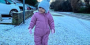 Izabella joined the competition — help win amazing prizes! blue_sky, child, clothing, cold_weather, footwear, frost, gloves, knitted_hat, morning, outdoor, parked_cars, person, pink_snowsuit, sidewalk, smile, snow, suburban, toddler, trees, winter