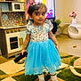 Izabella is registered to the contest to win money with this photo: blue_dress, carpet, child, curtains, flowers, furniture, girl, headband, indoor, jewelry, living_room, plush_toys, portrait, remote_control, shoes, smiling, socks, television, toy_kitchen, vase
