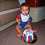 baby, birthday_cake, blue_eyes, cake, carpet, celebration, child, clothing, denim_overalls, event, face, foot, holiday, indoor, patriotic, person, photography, red_white_blue, sitting, young_child
