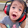 toddler, child, baby, portrait, face, eyes, open_mouth, hearing_protection, earmuffs, headphones, red, gray_shirt, outdoor, construction_site, playground, road, background, closeup, surprised, person