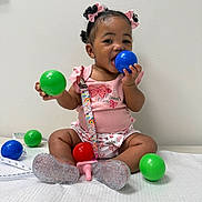 Jalena joined the competition — help win amazing prizes! baby, child, girl, pink_bows, blue_ball, green_ball, red_ball, play, smile, cute, sitting, indoors, measuring_tape, sparkly_shoes, pink_outfit, colorful_balls, happy, tongue_out, curly_hair, accessory