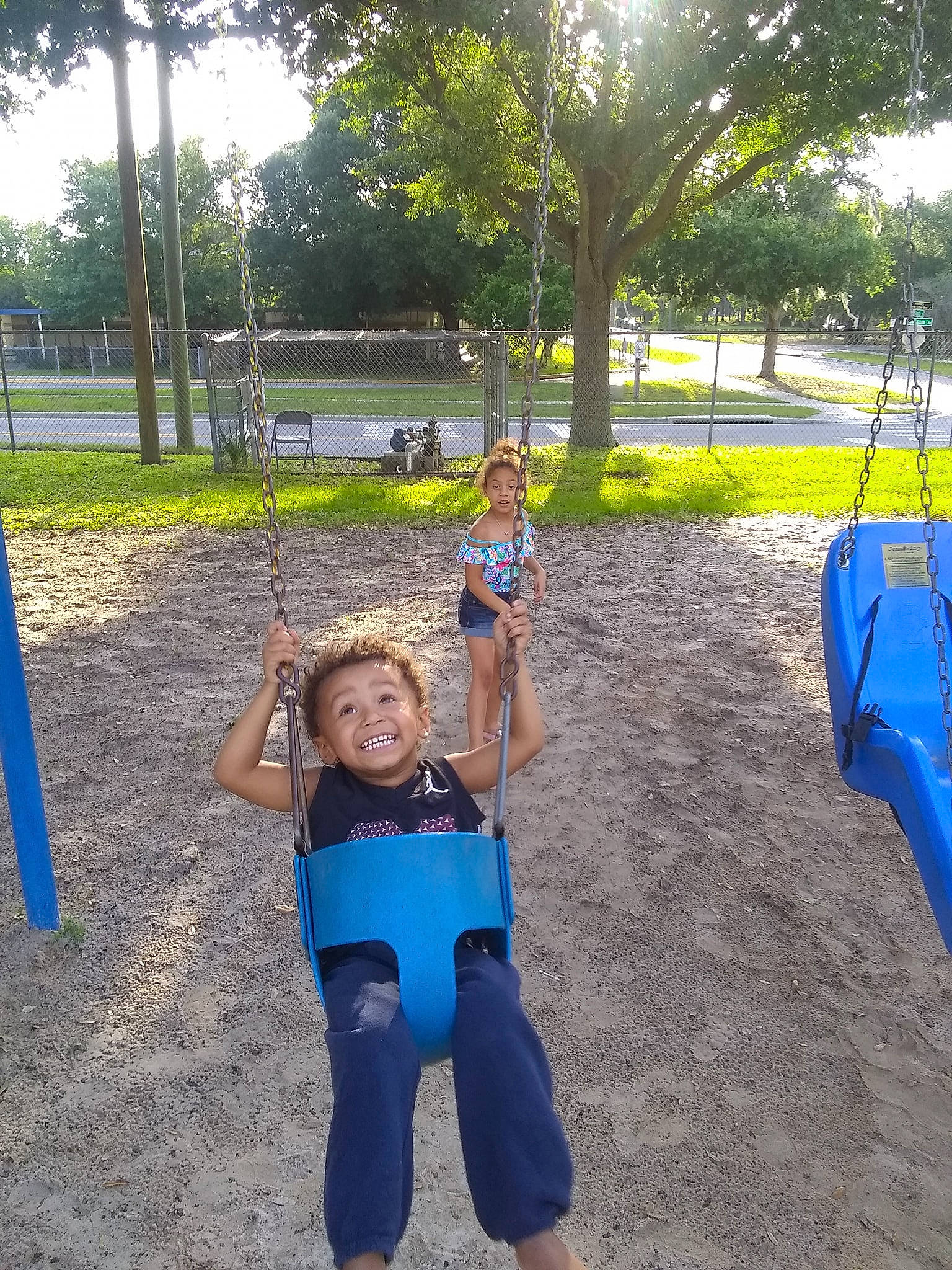 Carmelo is registered to the contest to win money with this photo: child, fun, joy, leisure, outdoor_play_equipment, park, person, play, playground, public_space, recreation, smile, summer, toddler, tree, vacation