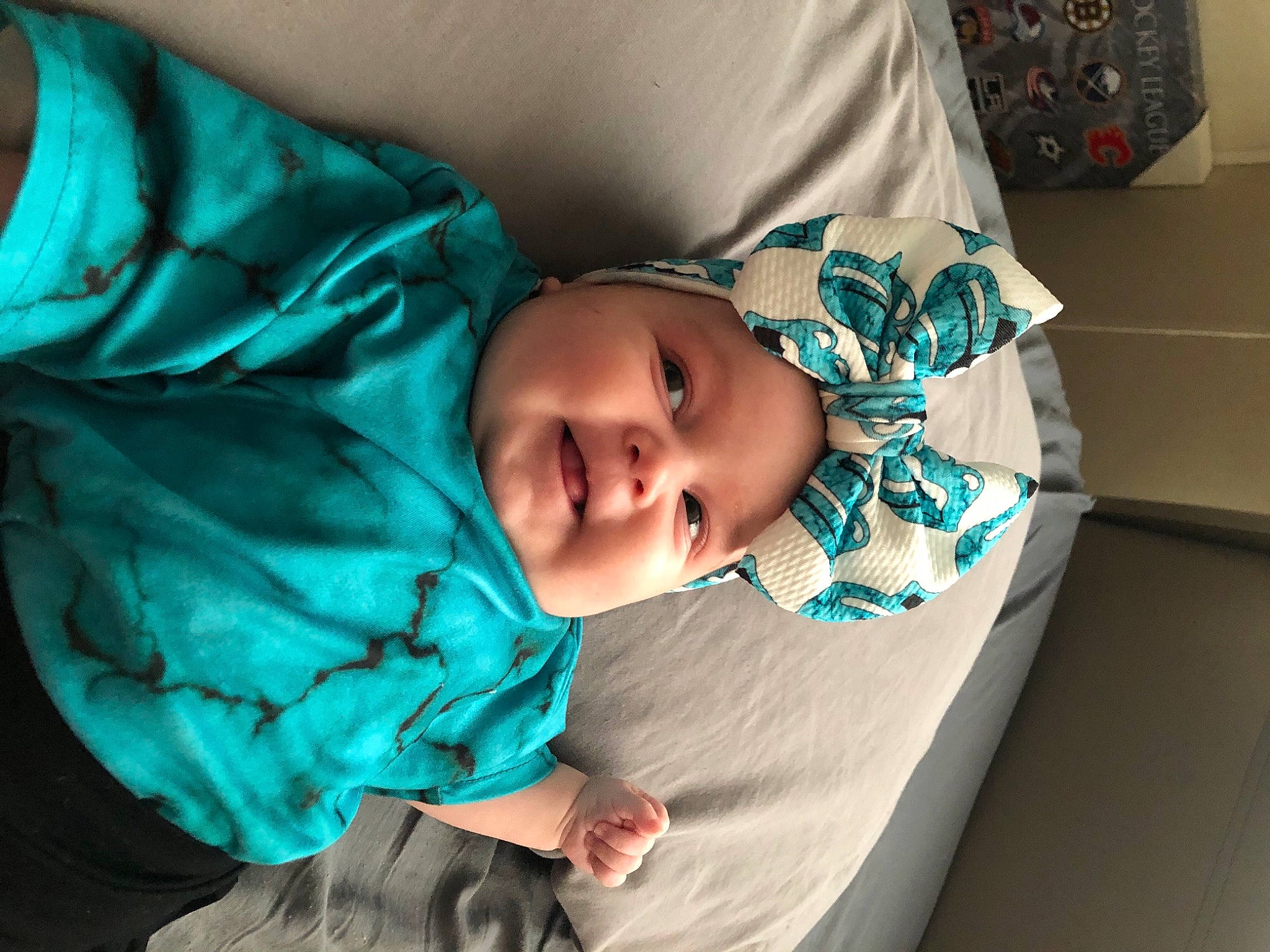 Londynn is registered to the contest to win money with this photo: baby, baby_toddler_clothing, box, carton, cheek, comfort, headwear, linens, person, shipping_box, teal, toddler, turquoise