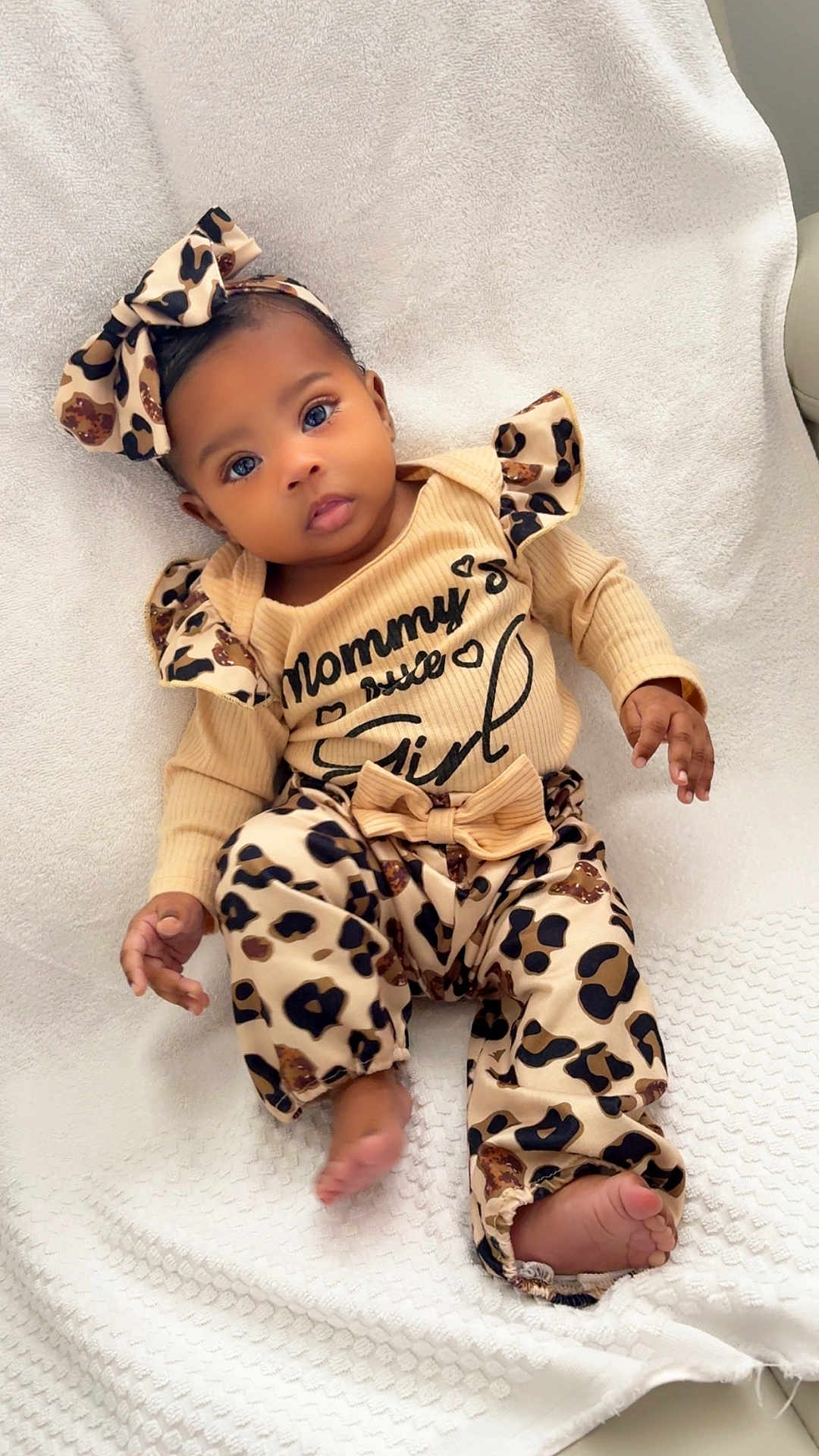 Aurora joined the competition — help win amazing prizes! baby, infant, child, cute, leopard_print, headband, bow, clothing, soft_blanket, white, sitting, portrait, indoors, feet, hands, looking_at_camera, expression, comfortable, adorable, person