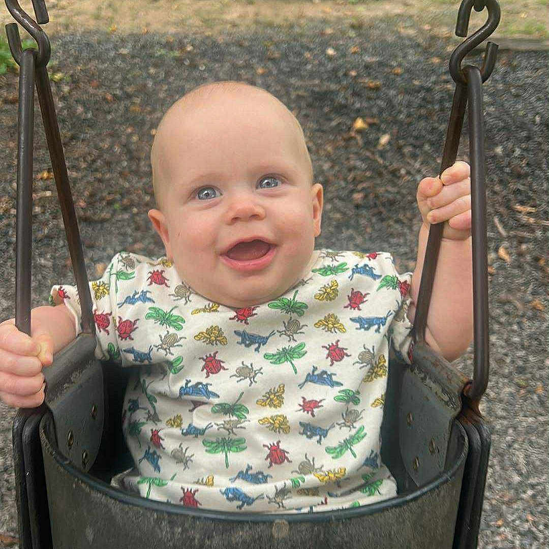 Kenneth is registered to the contest to win money with this photo: baby, casual, chains, child, clothing, daylight, fun, grass, happy, infant, nature, outdoor, park, person, play, playground, seat, shorts, smiling, swing