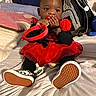 Starr joined the competition — help win amazing prizes! baby, child, tutu, red_clothing, black_clothing, shoes, checkered_shoes, toy, fuzzy_toy, bed, pillow, backpack, striped_backpack, indoor, curious, sitting, cute, infant, hands, face