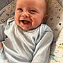 baby, smiling, infant, child, onesie, cushion, dinosaur_pattern, seat, happy, drool, face, head, cute, indoors, comfort, young, portrait, clothing, baby_girl_or_boy, expression