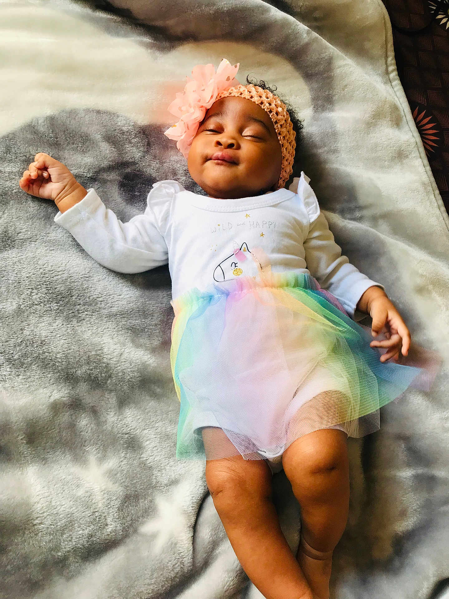 Ithalam Isipho is registered to the contest to win money with this photo: baby, infant, girl, headband, flower, unicorn, tutu, rainbow, blanket, star_pattern, sleeping, white_clothing, cute, soft_texture, relaxed, indoors, child, portrait, peaceful, smiling