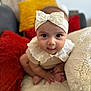 Lily Rose participe au concours pour gagner de l'argent avec cette photo : baby, infant, headband, bow, face, eyes, cushion, pillow, red_pillow, yellow_pillow, white_clothing, sitting, indoors, soft_texture, cute, child, portrait, closeup, homedecor, furniture