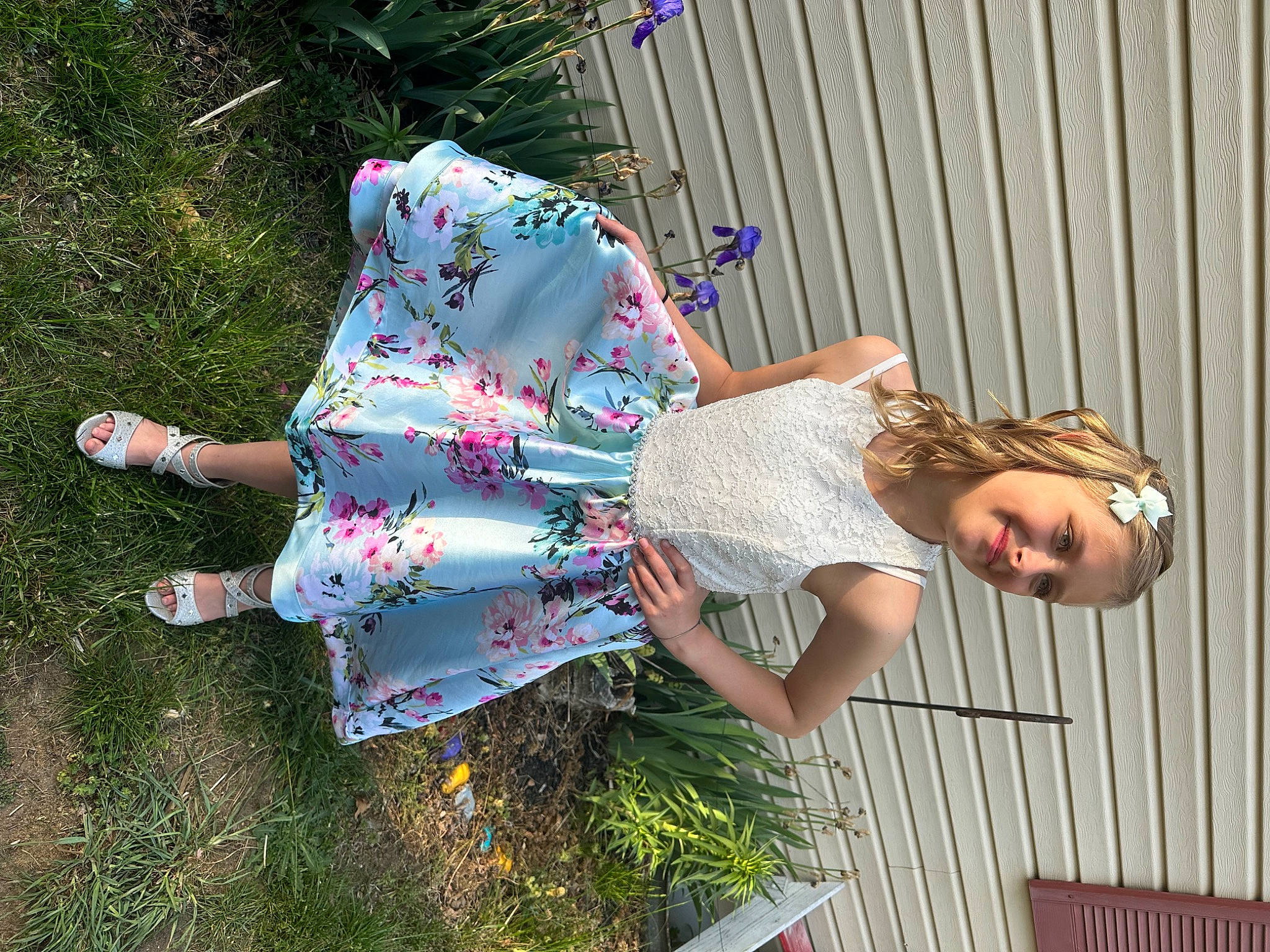 Haidyn Rose is registered to the contest to win money with this photo: child, dress, eyewear, fun, grass, happy, human_leg, joy, leisure, magenta, pattern, people_in_nature, person, pink, plant, sandal, sitting, thigh, vacation, waist